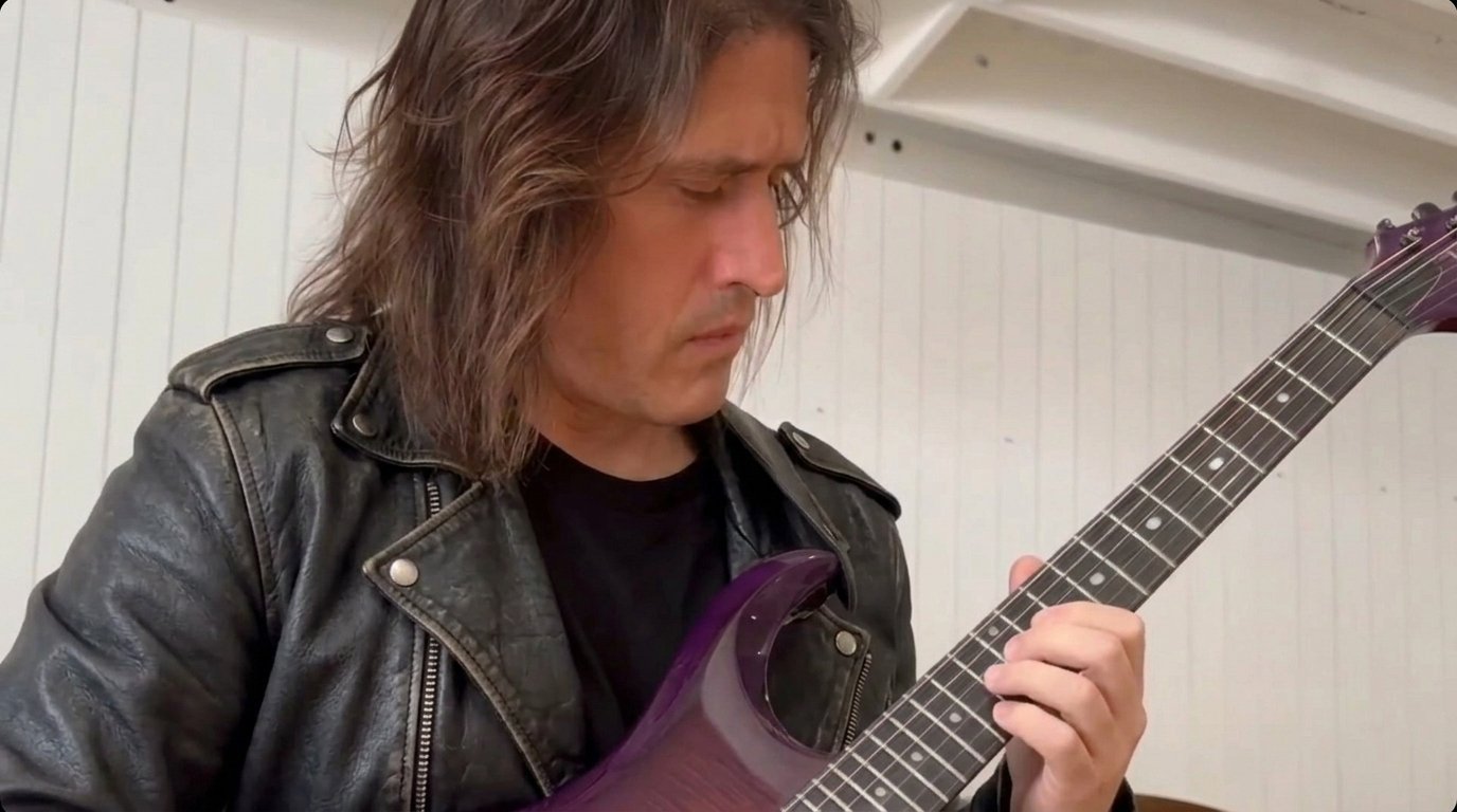 George S. Pogacich playing guitar, close-up